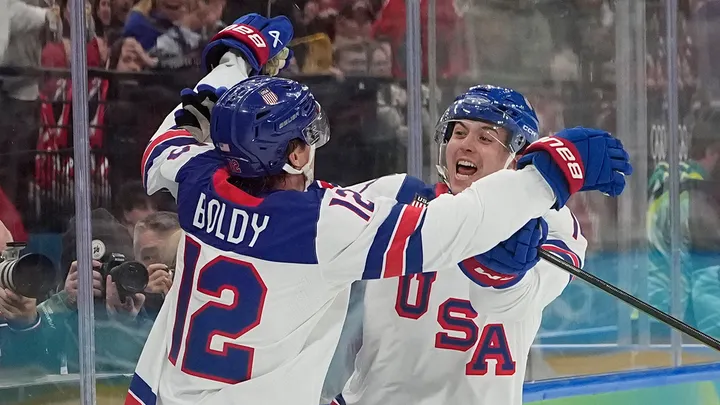 United States' Matt Boldy, left, celebrates after scoring the opening goal during a men's ice hockey gold medal game between Canada and the United States at the 2026 Winter Olympics, in Milan, Italy, Sunday, Feb. 22, 2026.  (AP Photo/Hassan Ammar)